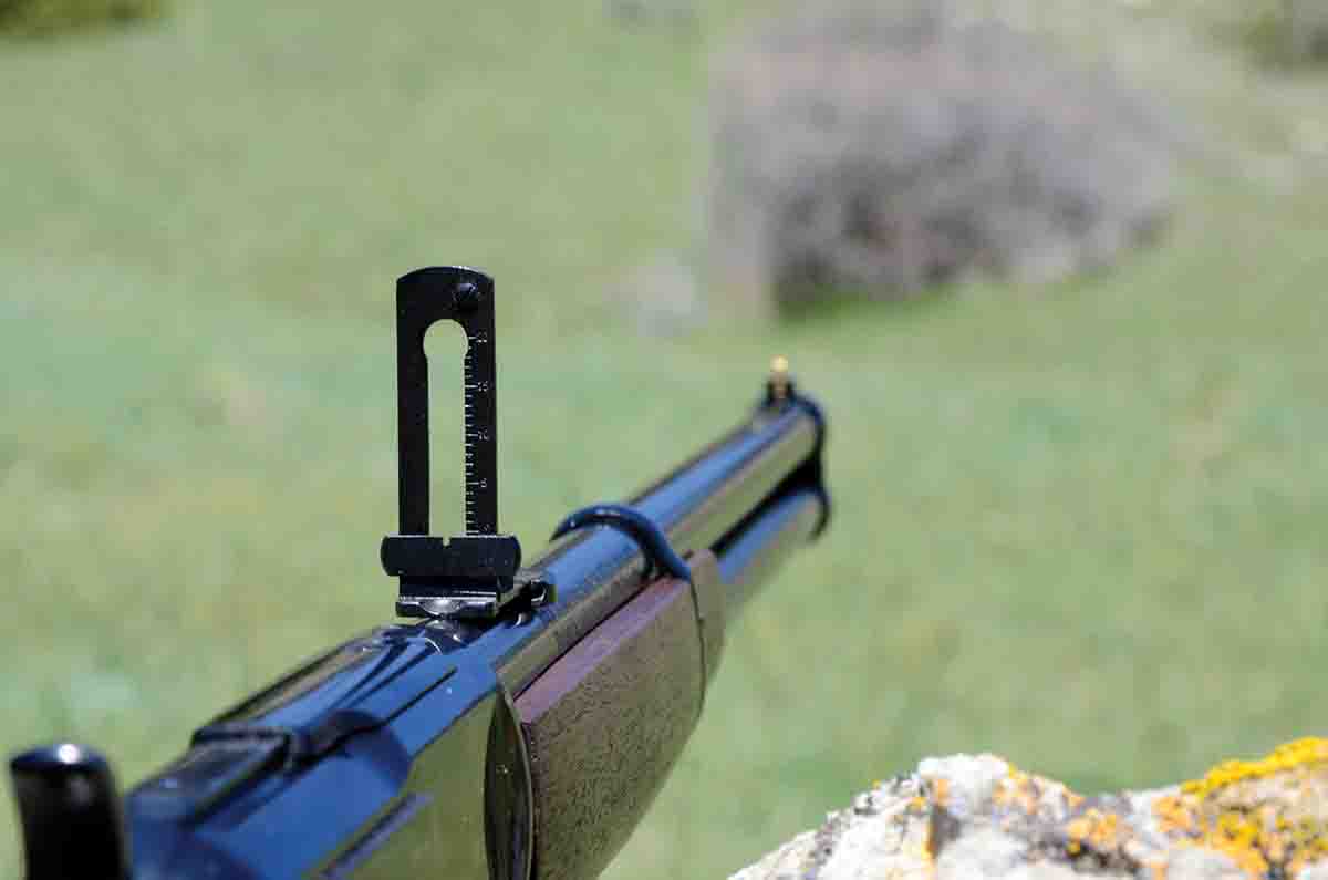 The rear sight on the Winchester SRC is a flip-up type with a notched slider for elevation.
